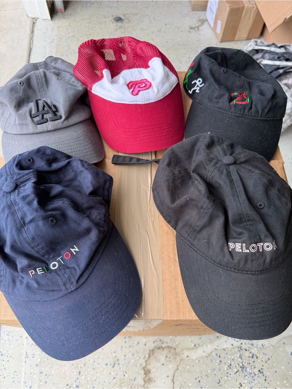 5 different hats 4 Peloton and one LA hat.